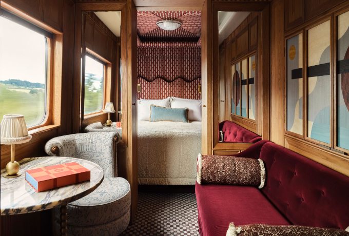 Belmond Britannic luxury train bedroom with plush bedding and large picture window overlooking the British countryside