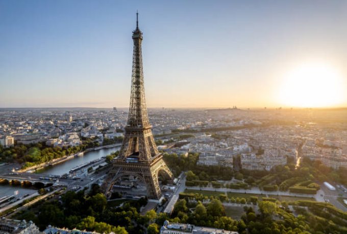 Aerial view of the Eiffel Tower and the Seine River in Paris representing the top cities and towns of France
