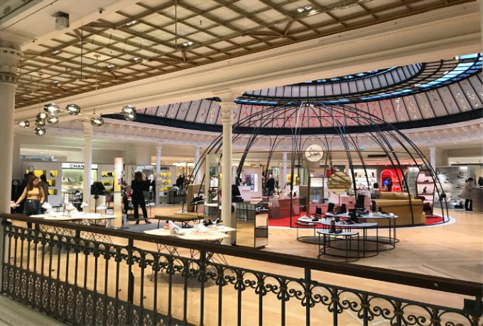 Interior of Galeries Lafayette in Paris with iconic glass dome and luxury designer boutiques
