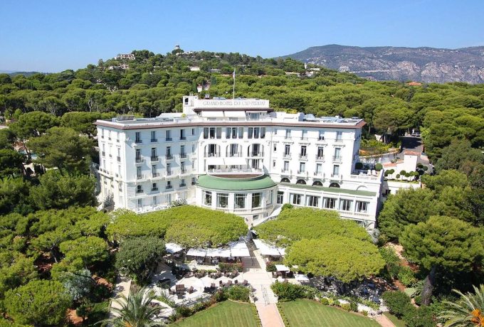 Front view of the Grand-Hôtel du Cap-Ferrat on the French Riviera surrounded by gardens and Mediterranean sea views