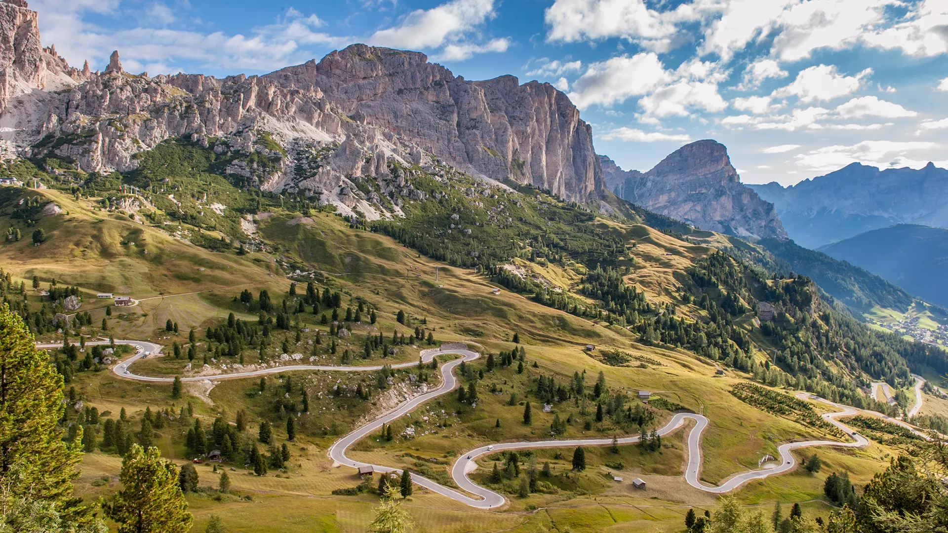 Driving through a mountain pass in the Dolomites, Italy with panoramic alpine views