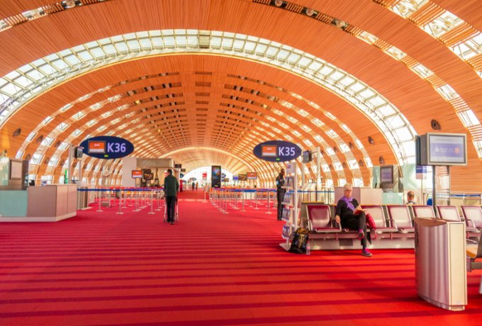 Paris Charles de Gaulle Airport terminal with planes and passengers.
