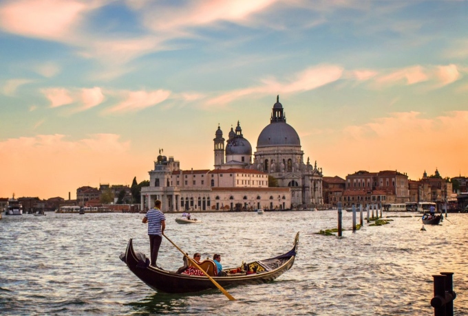 Gondolas on the Grand Canal at sunset in Venice, Italy with Santa Maria della Salute in the background